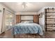 Comfortable bedroom featuring a modern Murphy bed and wood-look floors at 7608 W Mescal St, Peoria, AZ 85345
