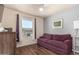 Bright bedroom featuring a comfortable sofa and large window at 7608 W Mescal St, Peoria, AZ 85345