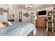 Cozy bedroom boasts a decorative barn door and wood-look flooring at 7608 W Mescal St, Peoria, AZ 85345