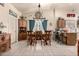 Bright dining room with stylish chandelier, tile flooring, and natural light from a large window at 7608 W Mescal St, Peoria, AZ 85345