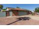 Side view of home with solar panels, a well maintained two car garage and desert landscaping at 7608 W Mescal St, Peoria, AZ 85345