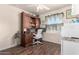 Home office with wood-look floors, built-in desk, and plenty of natural light at 7608 W Mescal St, Peoria, AZ 85345