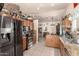 Spacious kitchen with stainless steel appliances, granite countertops, and tile flooring at 7608 W Mescal St, Peoria, AZ 85345