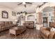 Open living room with plank floors, comfortable leather sofas, and decorative columns at 7608 W Mescal St, Peoria, AZ 85345