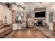 Inviting living room featuring stone fireplace, columns, archways, and tile floors at 7608 W Mescal St, Peoria, AZ 85345