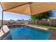 Sparkling pool with shade cover, slide and fenced-in area for safety at 7608 W Mescal St, Peoria, AZ 85345