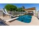 Backyard pool with slide, diving board, and outdoor dining under a pergola at 7608 W Mescal St, Peoria, AZ 85345