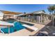 Backyard pool with diving board, slide, sunshade, dining, and fenced perimeter at 7608 W Mescal St, Peoria, AZ 85345