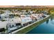 Aerial view of lakeside homes with landscaped yards, terra cotta tile roofs, and waterfront access at 8429 E Del Camino Dr, Scottsdale, AZ 85258