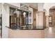 Modern bar area with sleek countertops, mirrored backsplash, and stylish wine-themed decor at 8429 E Del Camino Dr, Scottsdale, AZ 85258