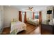 Bright bedroom with twin beds, hardwood floors, and natural light, ideal for a comfortable living space at 8429 E Del Camino Dr, Scottsdale, AZ 85258