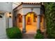 Grand entrance featuring stately columns, arched entryways, and a beautiful wooden door at 8429 E Del Camino Dr, Scottsdale, AZ 85258