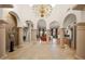 Expansive foyer features elegant columns, travertine flooring, and views into the living spaces at 8429 E Del Camino Dr, Scottsdale, AZ 85258
