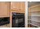 Modern kitchen with oven and shelving at 8429 E Del Camino Dr, Scottsdale, AZ 85258