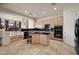 Gourmet kitchen featuring black countertops, an island, and ample cabinet space perfect for cooking at 8429 E Del Camino Dr, Scottsdale, AZ 85258