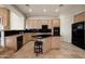 Well-equipped kitchen with light wood cabinets, dark countertops, and a center island with seating at 8429 E Del Camino Dr, Scottsdale, AZ 85258
