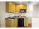 Modern kitchenette with sleek cabinets, granite countertops, and stainless steel appliances for convenient meal prep at 8429 E Del Camino Dr, Scottsdale, AZ 85258