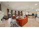 Spacious living room boasts curved windows, travertine floors, and an open floor plan at 8429 E Del Camino Dr, Scottsdale, AZ 85258