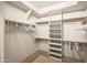 Spacious walk-in closet with ample shelving and hanging space for organized storage solutions at 8429 E Del Camino Dr, Scottsdale, AZ 85258