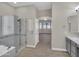 Bathroom with glass shower, soaking tub and vanity with views into another room at 8854 W Augusta Ave, Glendale, AZ 85305
