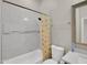Full bathroom showcasing a shower-tub combination with new tiling and a shower curtain at 8854 W Augusta Ave, Glendale, AZ 85305