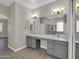 Bathroom featuring double sinks, large mirror, gray cabinets and separate shower at 8854 W Augusta Ave, Glendale, AZ 85305