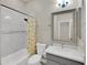 Bathroom featuring a shower-tub combination and a gray vanity with a gray framed mirror at 8854 W Augusta Ave, Glendale, AZ 85305