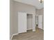 This is a spacious bedroom with wood-look tile flooring and a closet at 8854 W Augusta Ave, Glendale, AZ 85305