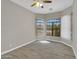 Bedroom with tile flooring, ceiling fan, and large windows with blinds and shutters at 8854 W Augusta Ave, Glendale, AZ 85305