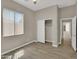 This is a spacious bedroom with wood-look tile flooring, window, and closet at 8854 W Augusta Ave, Glendale, AZ 85305