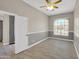 A cozy bedroom featuring a large window, open door, and great natural light at 8854 W Augusta Ave, Glendale, AZ 85305