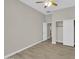 This is a spacious bedroom with wood-look tile flooring and a ceiling fan with light at 8854 W Augusta Ave, Glendale, AZ 85305