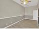 A cozy bedroom featuring a closed door, ceiling fan and neutral color walls at 8854 W Augusta Ave, Glendale, AZ 85305