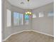 Bright dining area with large windows, blinds, tile floors, and modern lighting fixture at 8854 W Augusta Ave, Glendale, AZ 85305