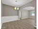 Open-concept dining room with tile flooring, white trim, and a chandelier at 8854 W Augusta Ave, Glendale, AZ 85305
