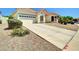 Inviting single-story home with two car garage, long driveway, and desert landscaping at 8854 W Augusta Ave, Glendale, AZ 85305