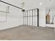 Spacious garage featuring white walls, finished floor and overhead storage system at 8854 W Augusta Ave, Glendale, AZ 85305