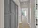 Hallway with storage cabinets leading to a room with natural light from a window at 8854 W Augusta Ave, Glendale, AZ 85305