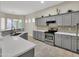 Well-equipped kitchen with stainless steel appliances, quartz countertops, and modern gray cabinetry at 8854 W Augusta Ave, Glendale, AZ 85305