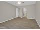 Spacious living room with tile flooring, ceiling fan, and doorways leading to other areas at 8854 W Augusta Ave, Glendale, AZ 85305