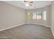 Bright living room with tile floors, ceiling fan, and plentiful windows with natural light and mountain views at 8854 W Augusta Ave, Glendale, AZ 85305