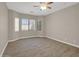 Bright living room with tile floors, ceiling fan, and plentiful windows with natural light at 8854 W Augusta Ave, Glendale, AZ 85305