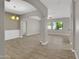Open-concept living room with tile flooring, white trim, and large archways at 8854 W Augusta Ave, Glendale, AZ 85305