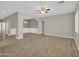 Inviting living room featuring tile flooring, neutral paint, and arched doorways for a modern touch at 8854 W Augusta Ave, Glendale, AZ 85305