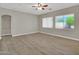 Cozy living space with tile floors, large windows, and a ceiling fan for a comfortable environment at 8854 W Augusta Ave, Glendale, AZ 85305