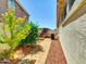Paver path in the side yard with desert landscaping and AC unit at 8854 W Augusta Ave, Glendale, AZ 85305