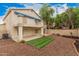 Spacious backyard with a manicured lawn, covered patio and balcony with a blue awning at 917 N Blackbird Dr, Gilbert, AZ 85234