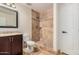 A remodeled bathroom with a tiled shower, a new vanity, a nice mirror and a toilet at 917 N Blackbird Dr, Gilbert, AZ 85234