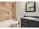 A remodeled bathroom with a tiled shower, a new vanity, a black framed mirror and a toilet at 917 N Blackbird Dr, Gilbert, AZ 85234