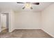 A large bedroom with neutral walls, vinyl floors, a ceiling fan and access to another room at 917 N Blackbird Dr, Gilbert, AZ 85234